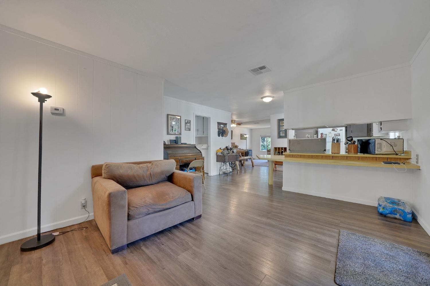 a living room with furniture and view of kitchen