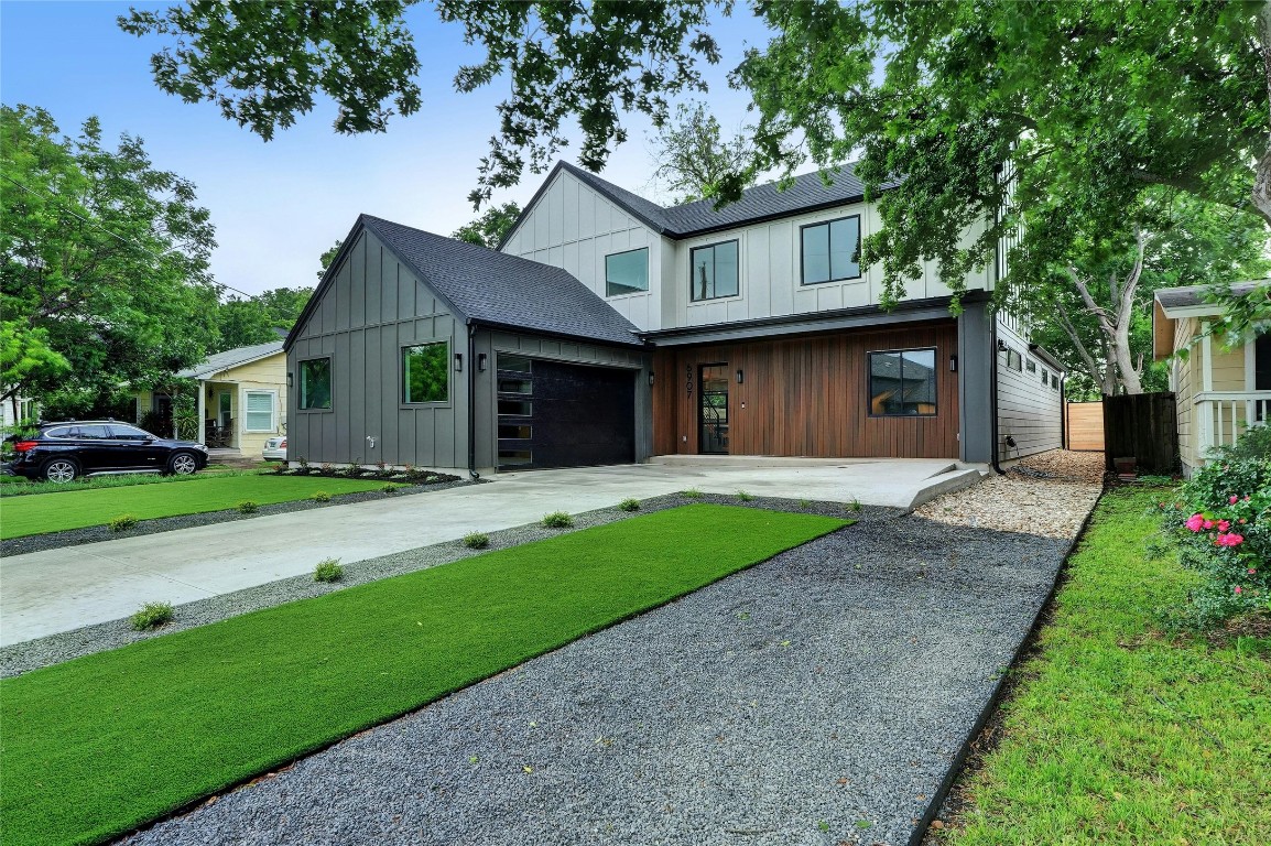 a front view of a house with a yard and garage