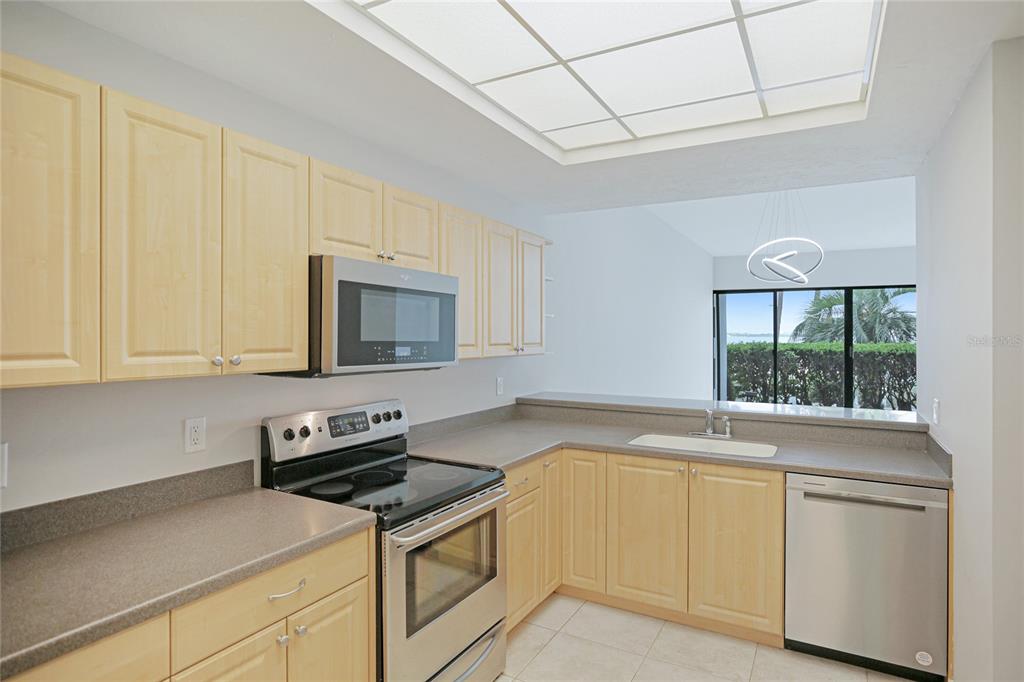 a kitchen with white cabinets and a stove top oven