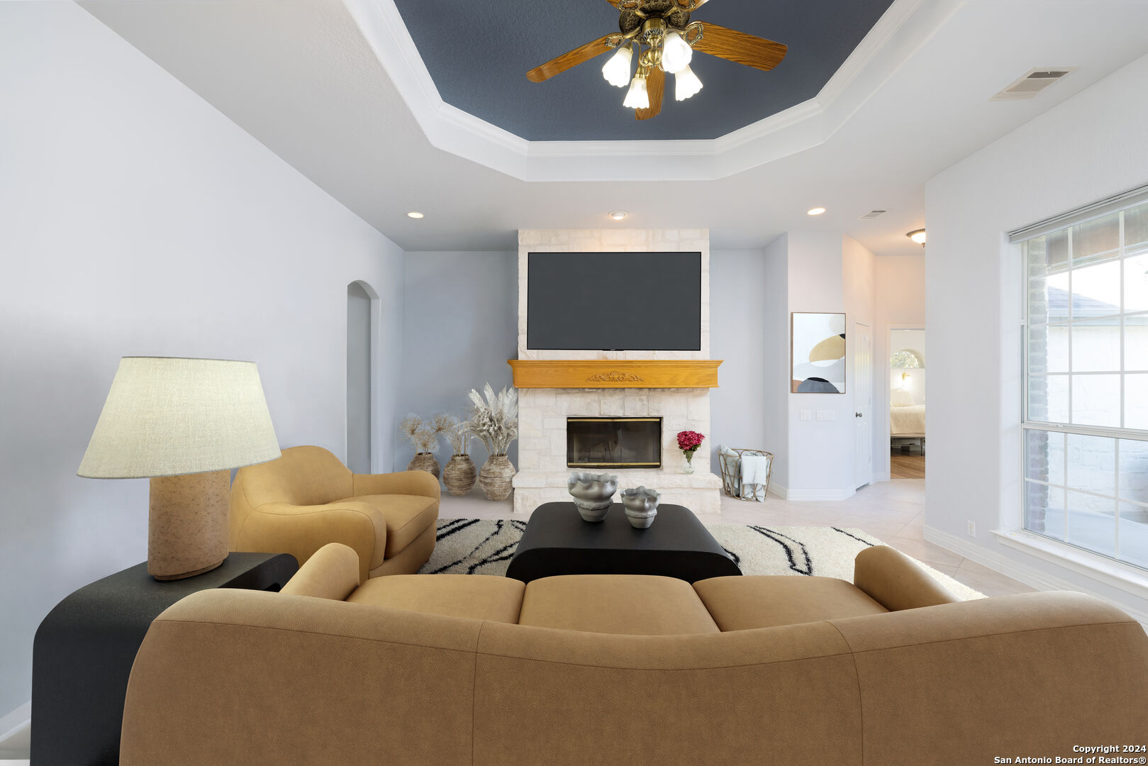 a living room with furniture a fireplace and a chandelier