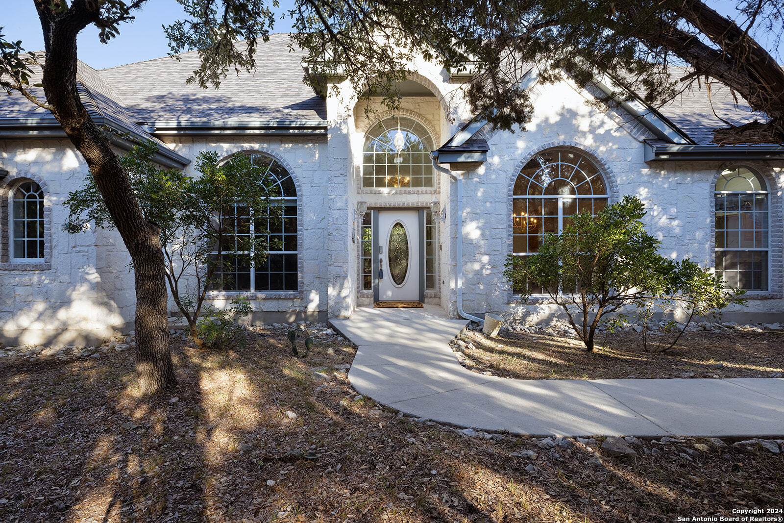 a front view of a house with garden