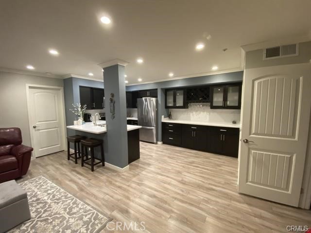 a large kitchen with kitchen island a sink a counter space and stainless steel appliances