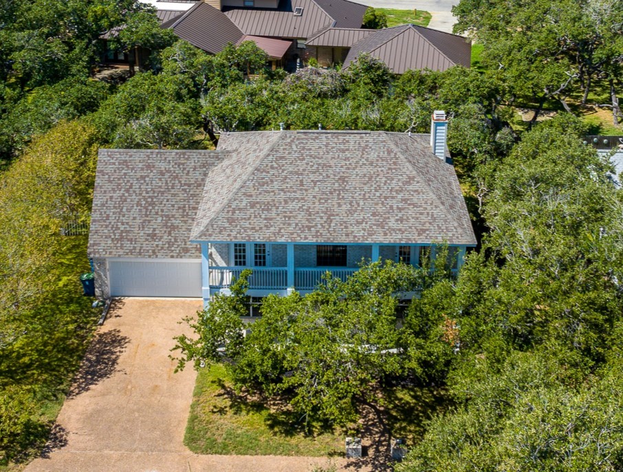 an aerial view of house with yard and outdoor seating