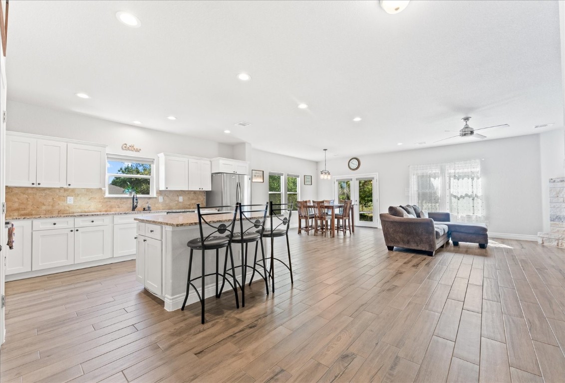 a open kitchen with white cabinets and stainless steel appliances