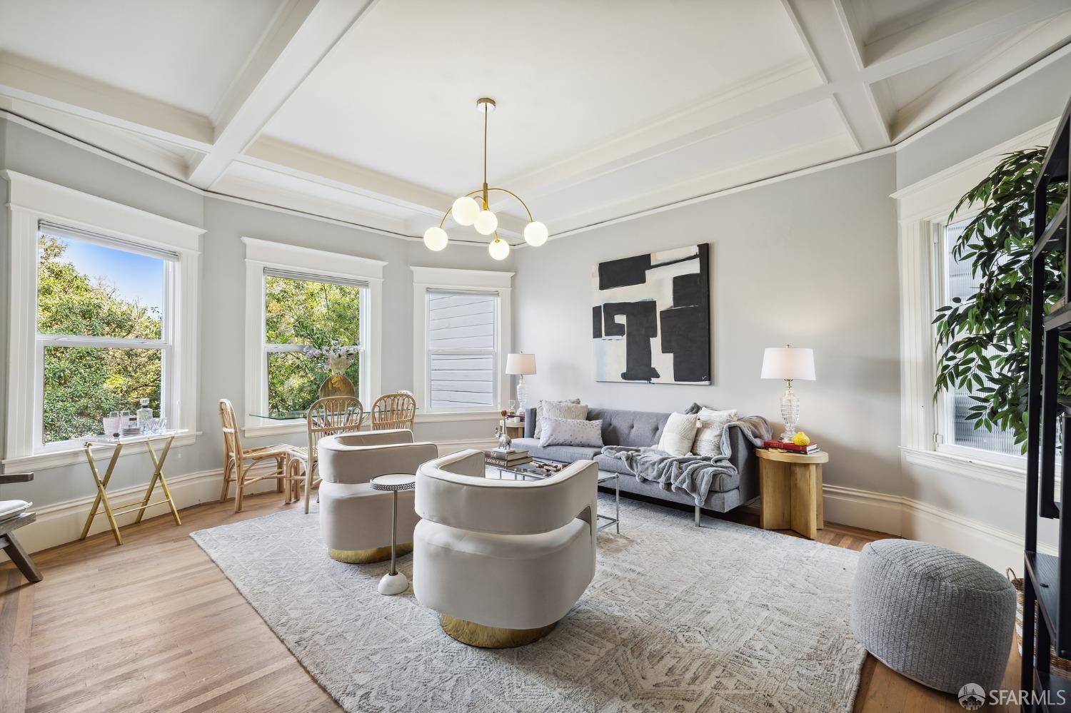 a living room with furniture and a chandelier