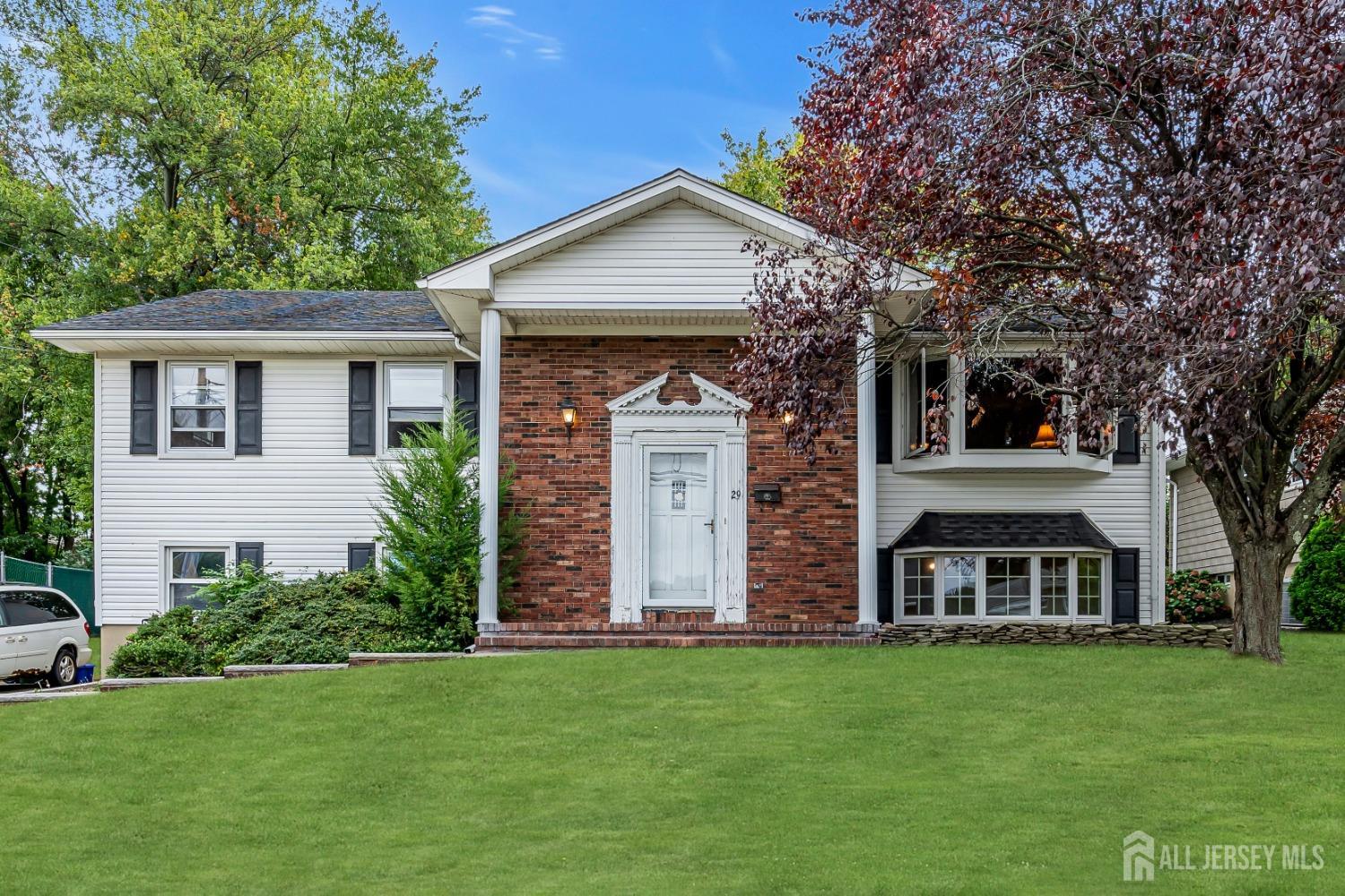 a front view of a house with a garden