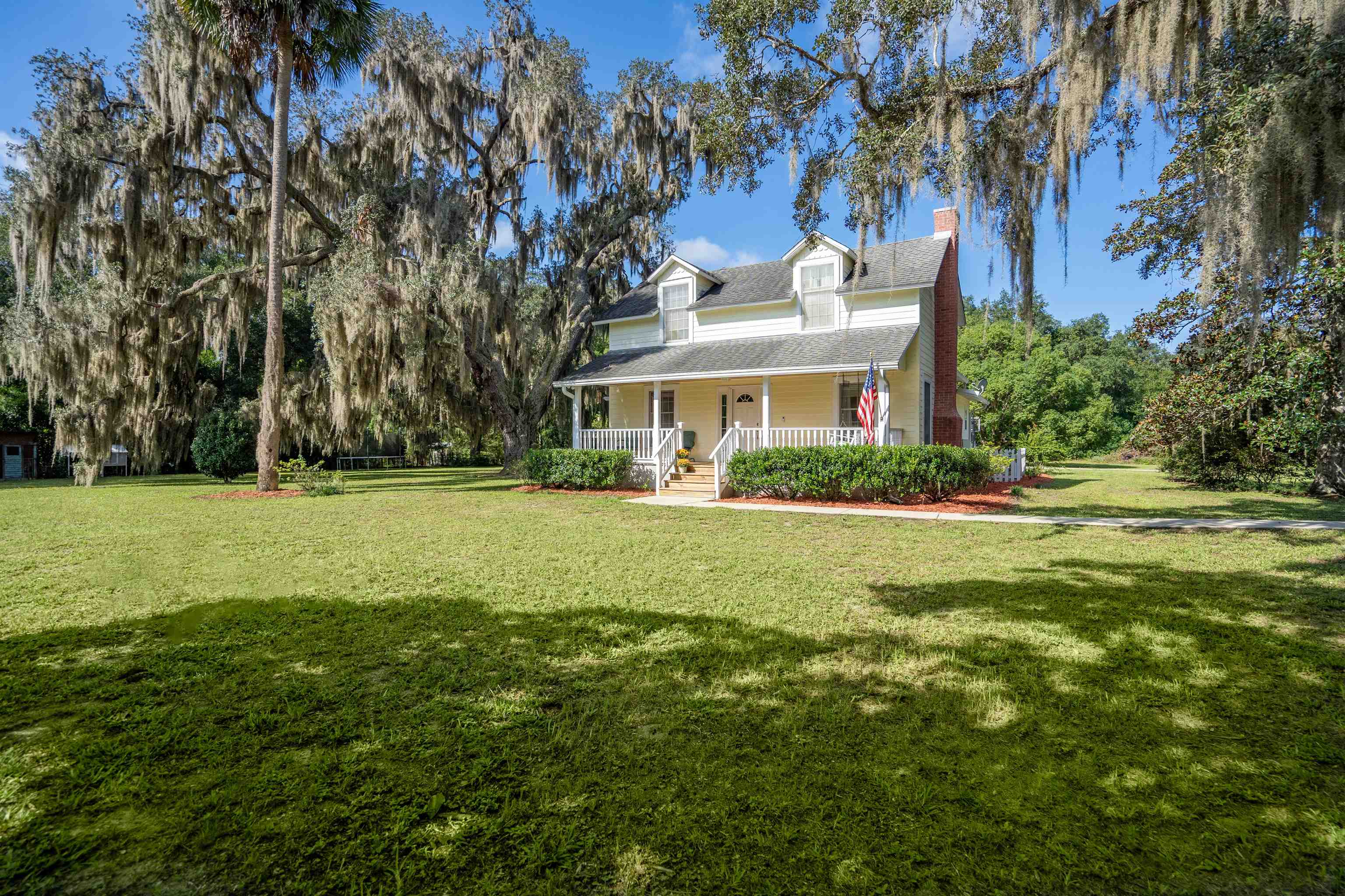 a front view of house with yard and green space