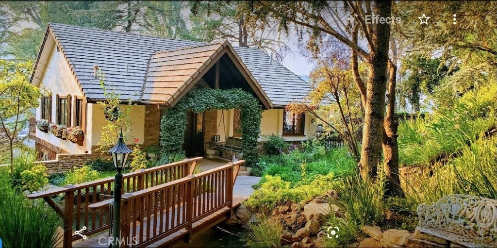 a view of a house with a wooden deck and furniture