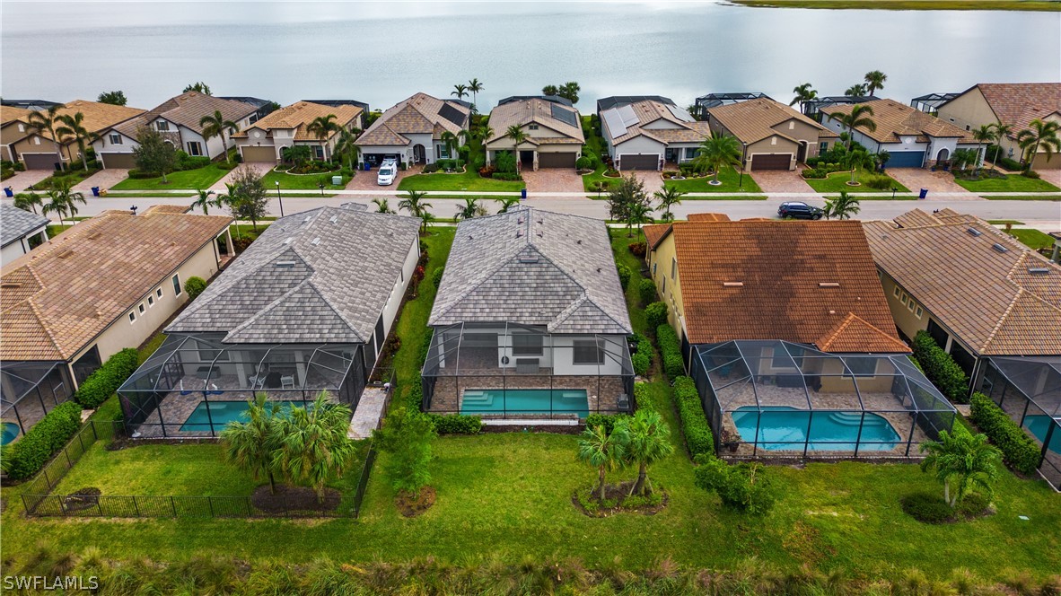 an aerial view of multiple houses with yard