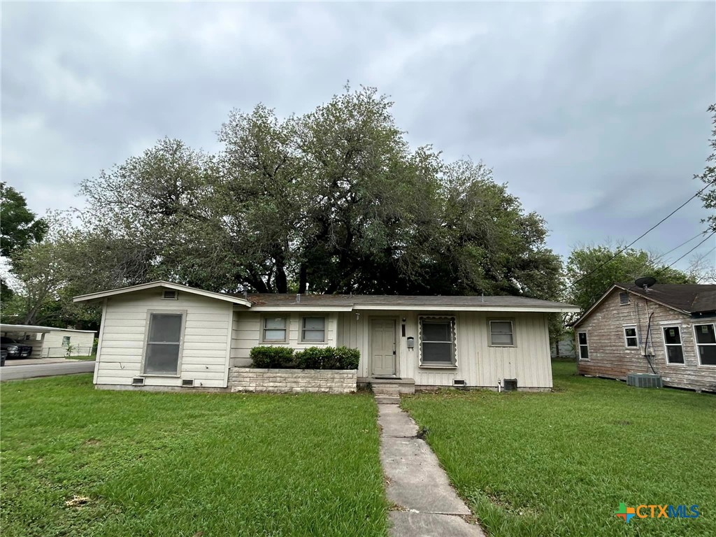 a front view of house with a garden