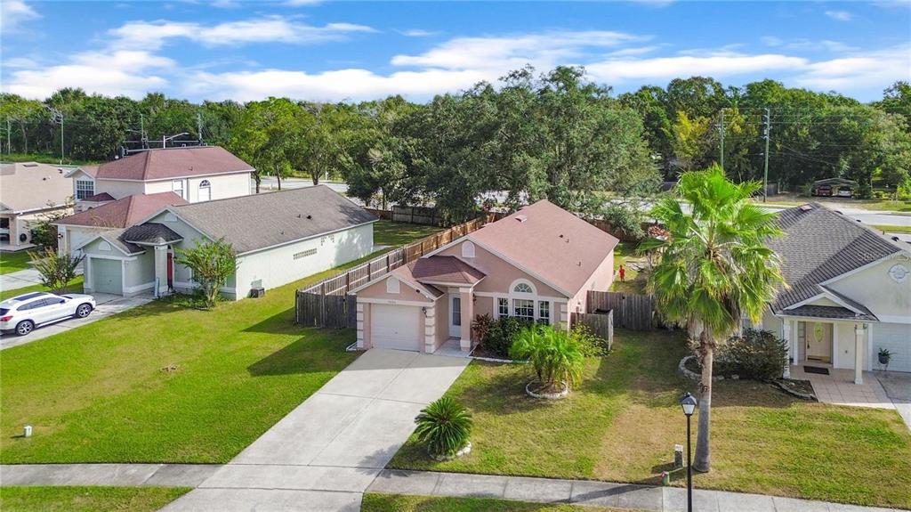 a aerial view of a house with a yard table and chairs