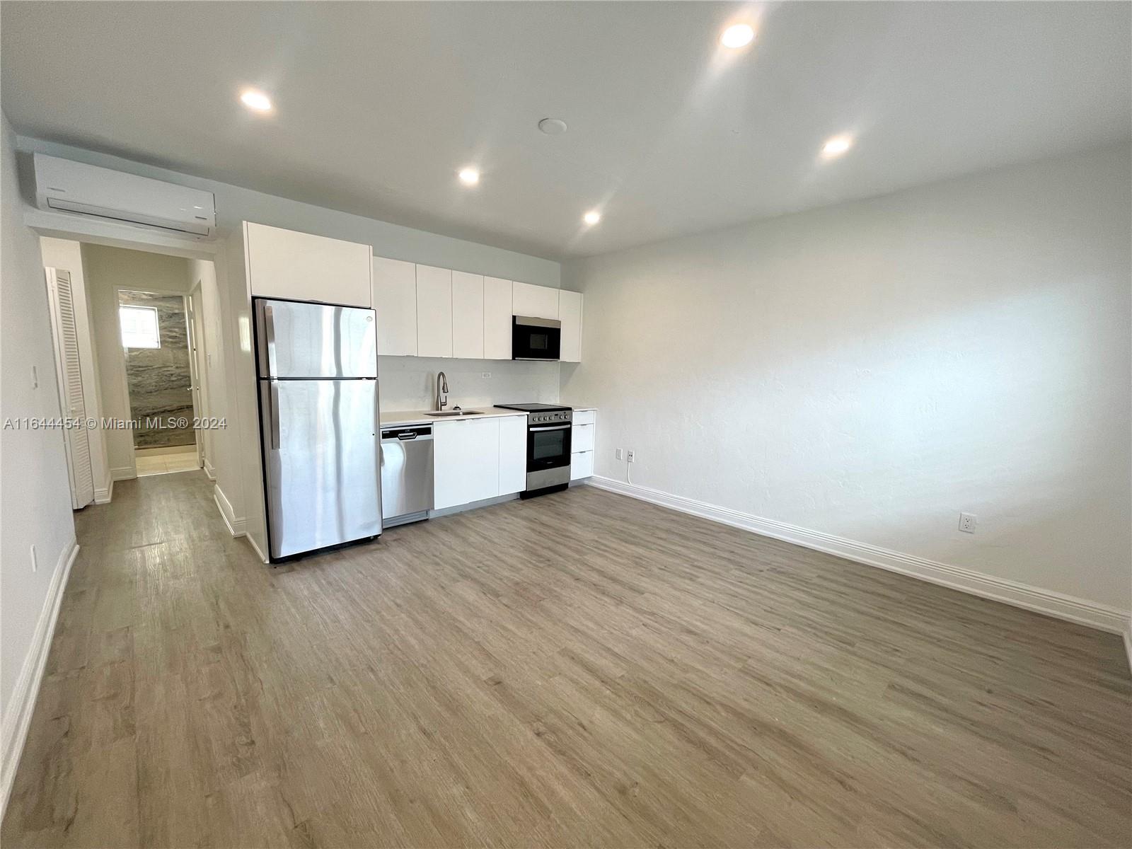 a view of kitchen with stainless steel appliances a refrigerator and a stove top oven