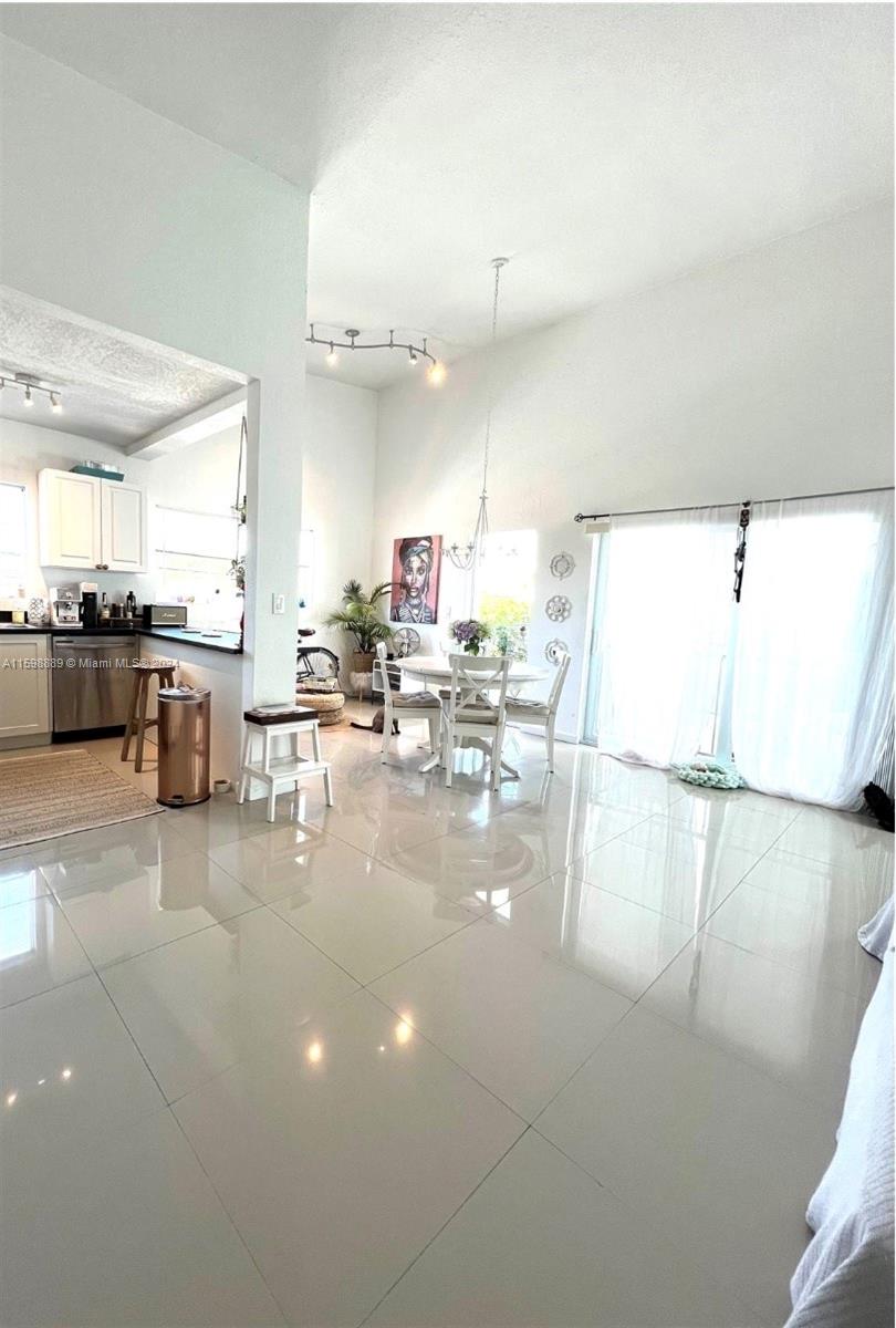 a kitchen with lots of counter top space and living room view