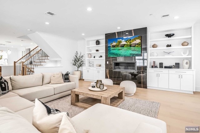 a living room with fireplace furniture and a flat screen tv