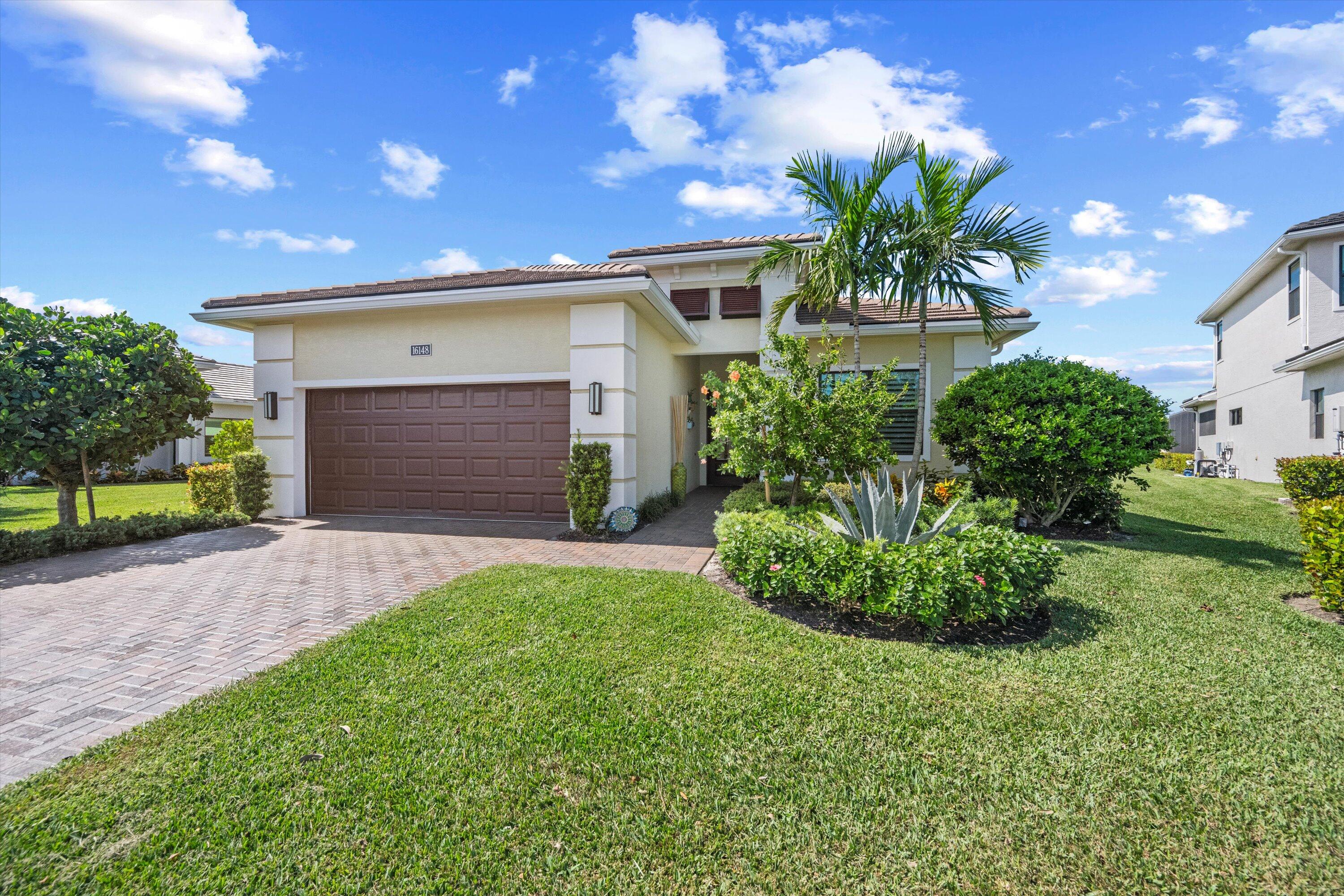 a front view of a house with a yard and garage