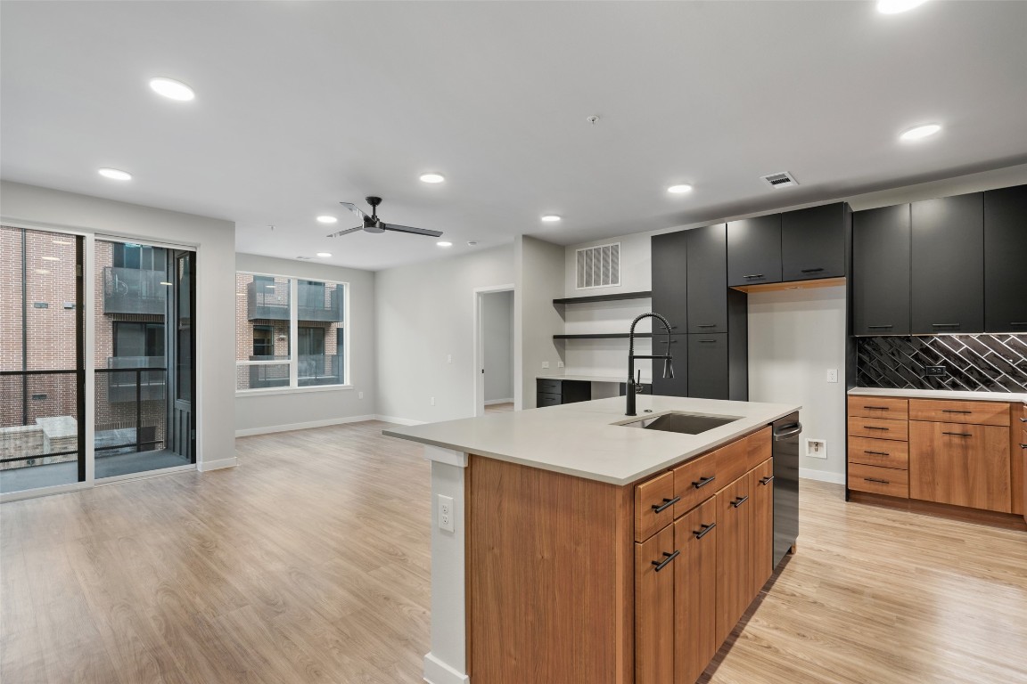 a kitchen with kitchen island a sink stove and refrigerator