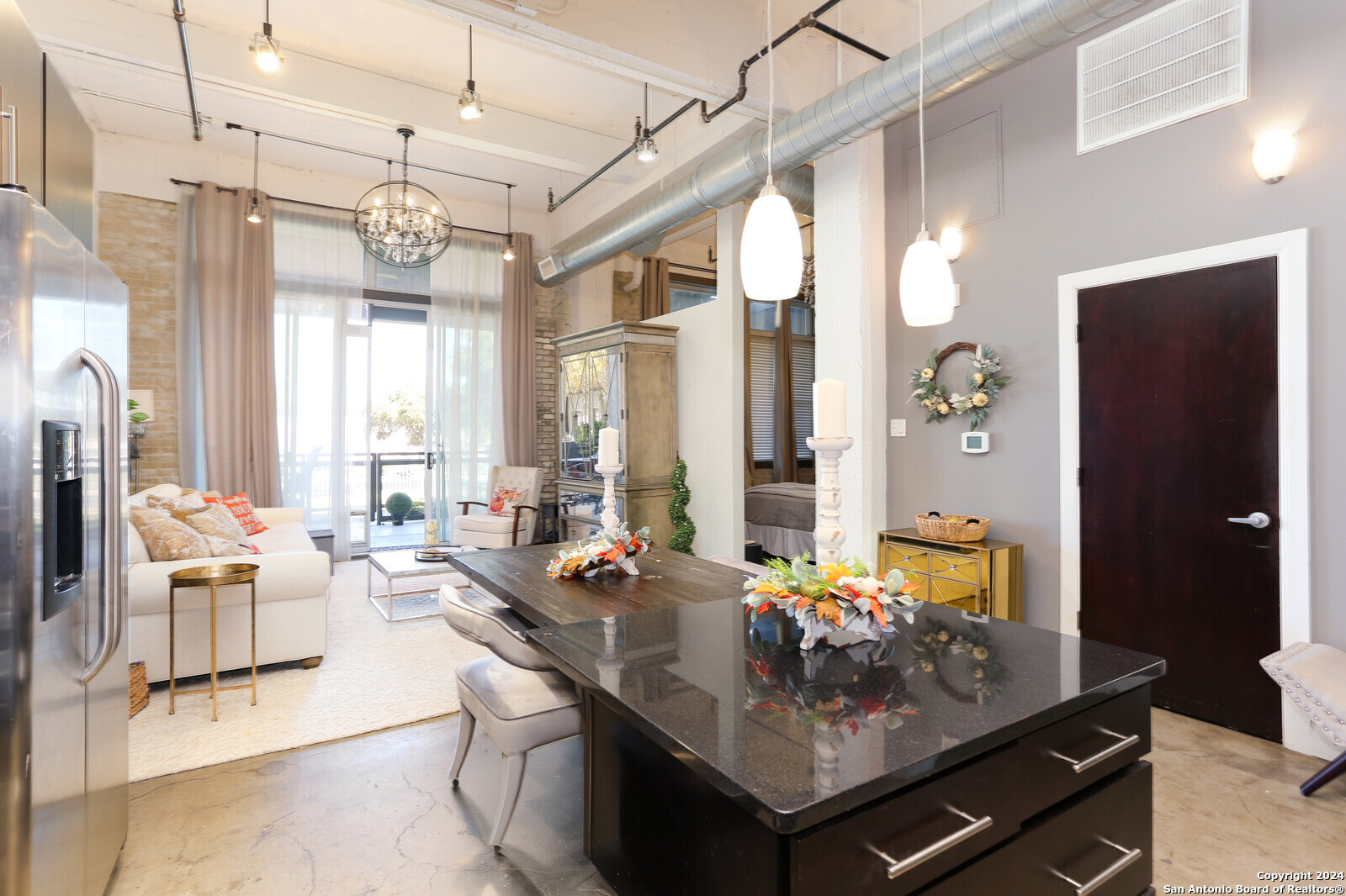 a living room with lots of furniture and a chandelier