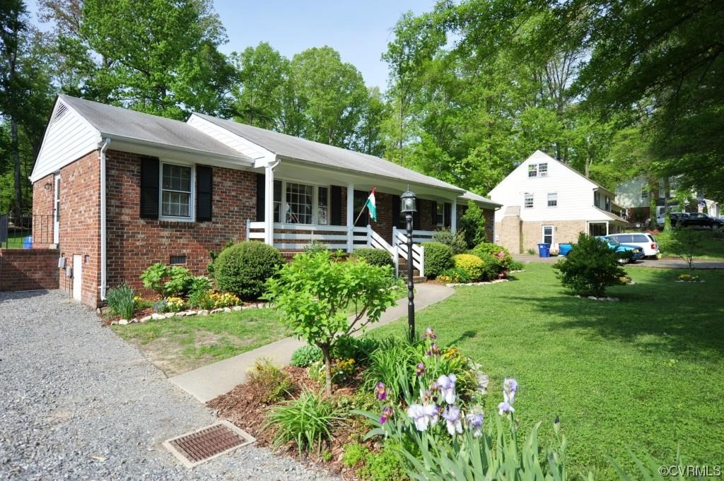 a front view of a house with a yard and porch