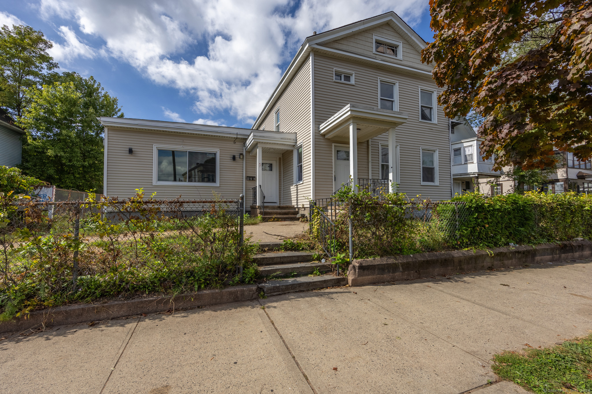 a front view of a house with a garden