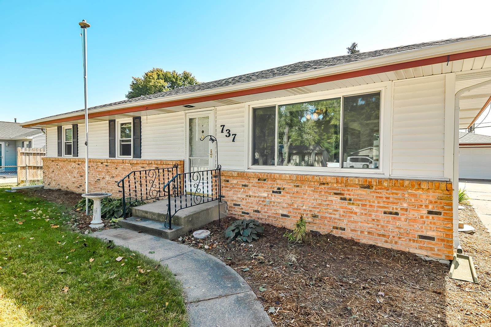 a view of a house with a wooden fence