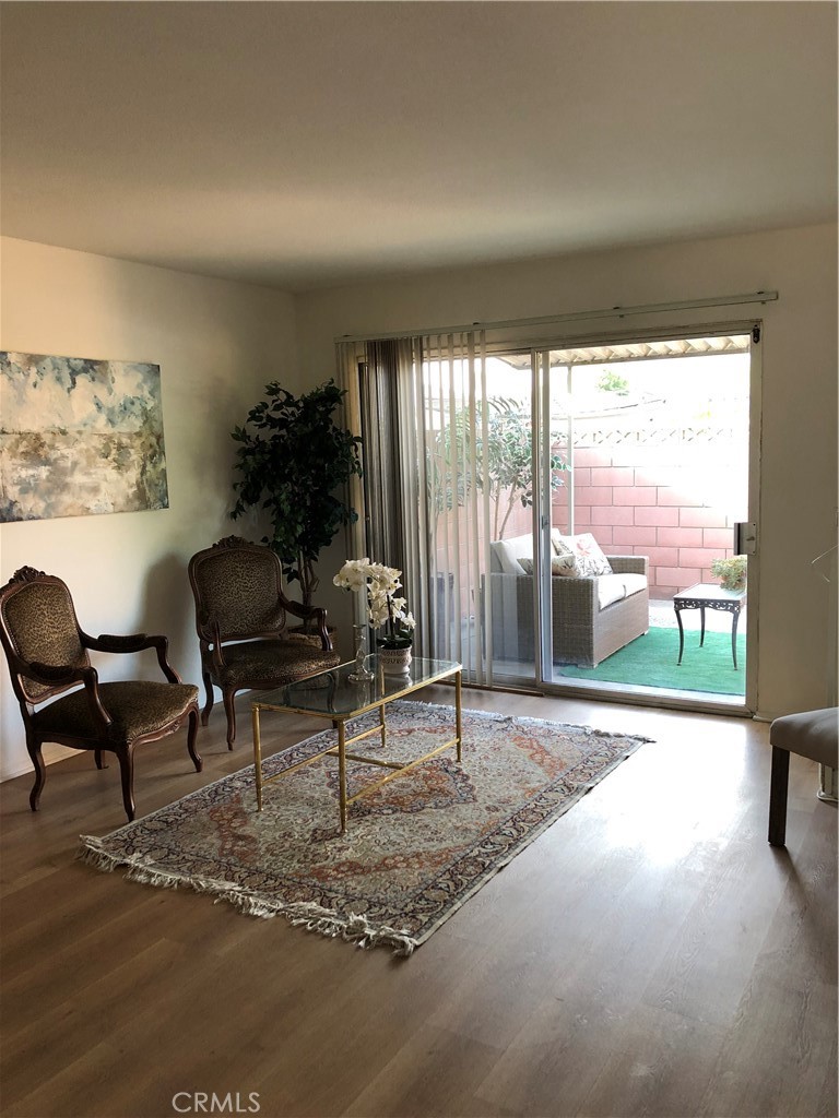 a living room with furniture and a floor to ceiling window