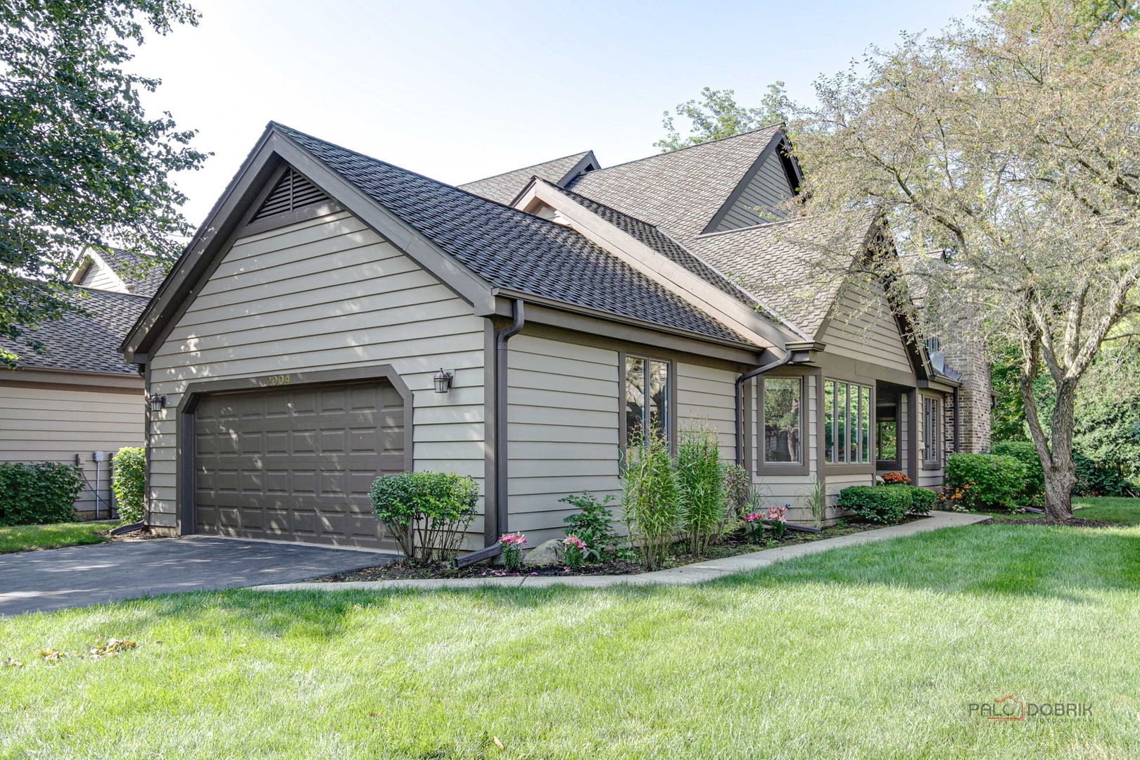 a front view of a house with a yard and garage