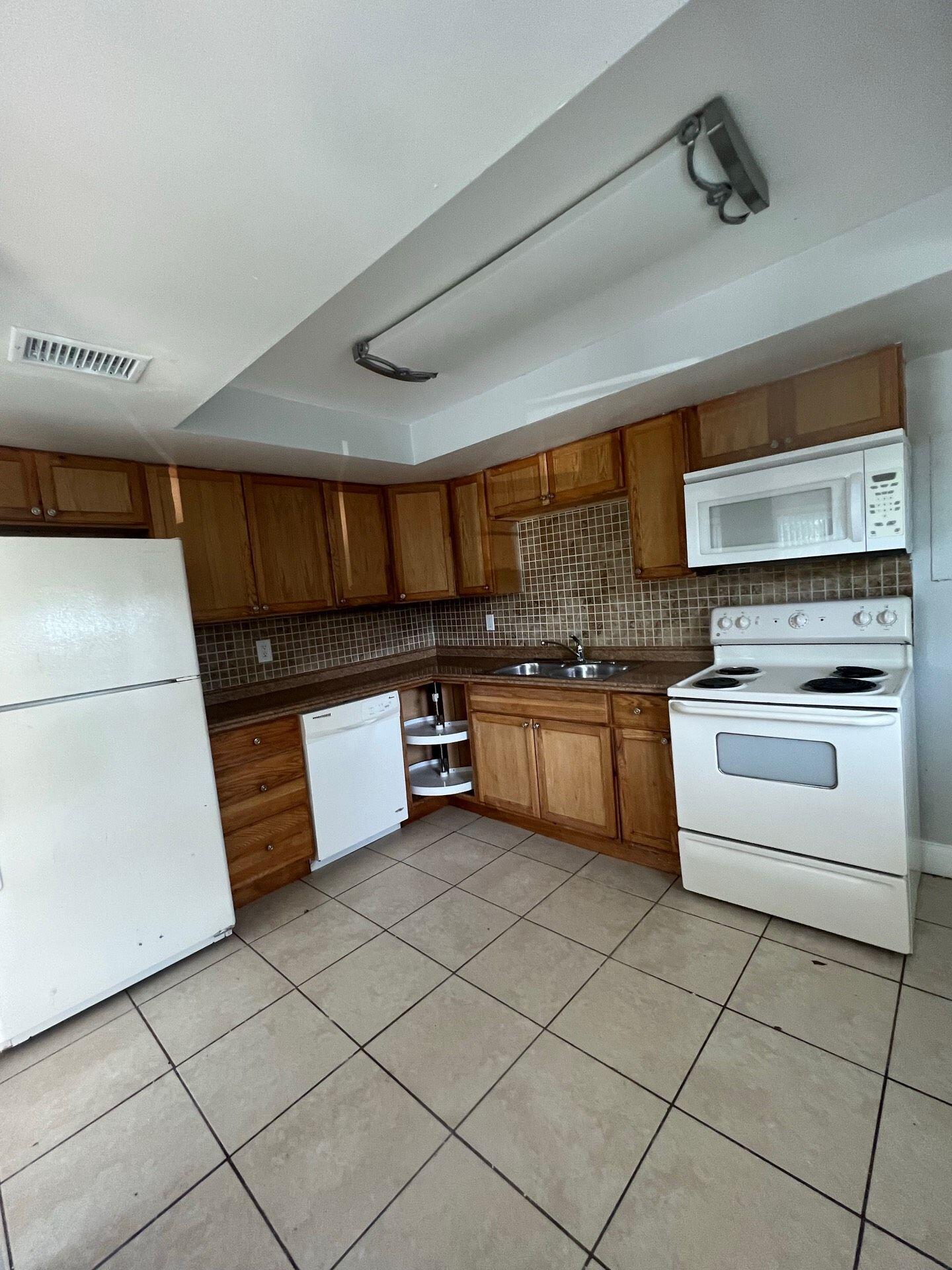 a kitchen with stainless steel appliances granite countertop a stove and a refrigerator