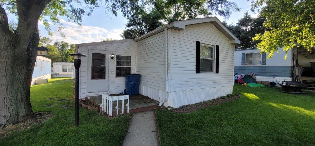 a view of a house with a yard porch and sitting area