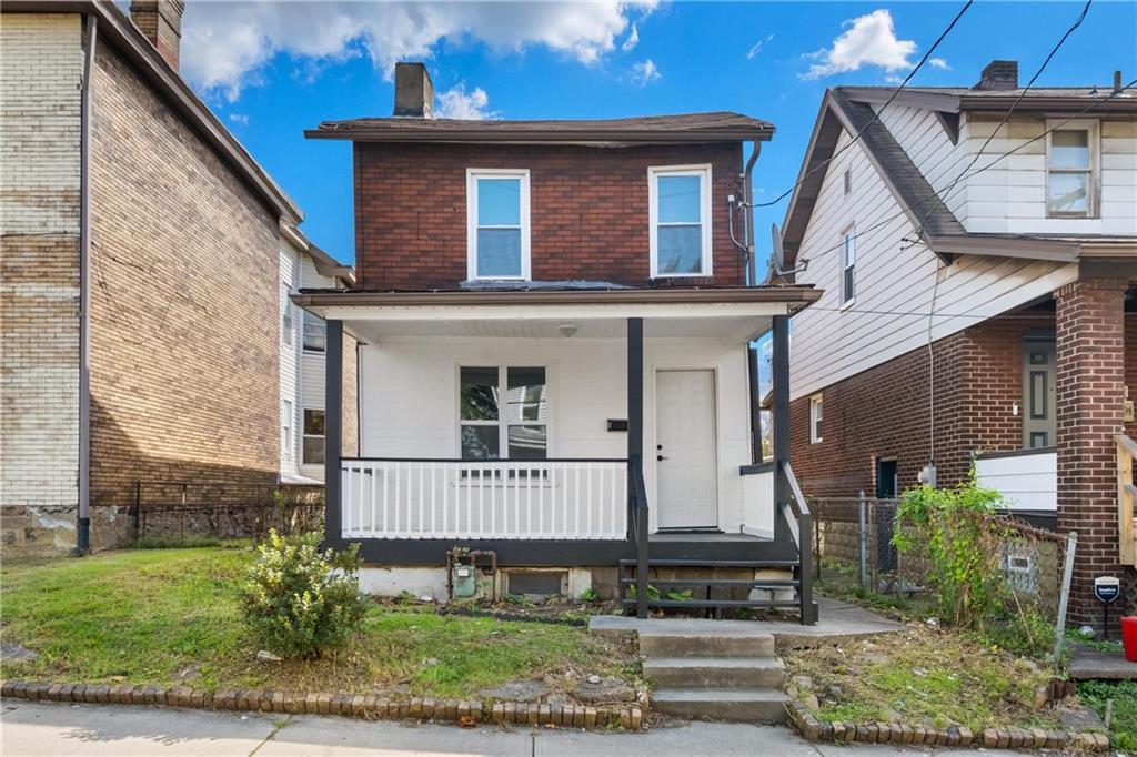 front view of a house with a yard