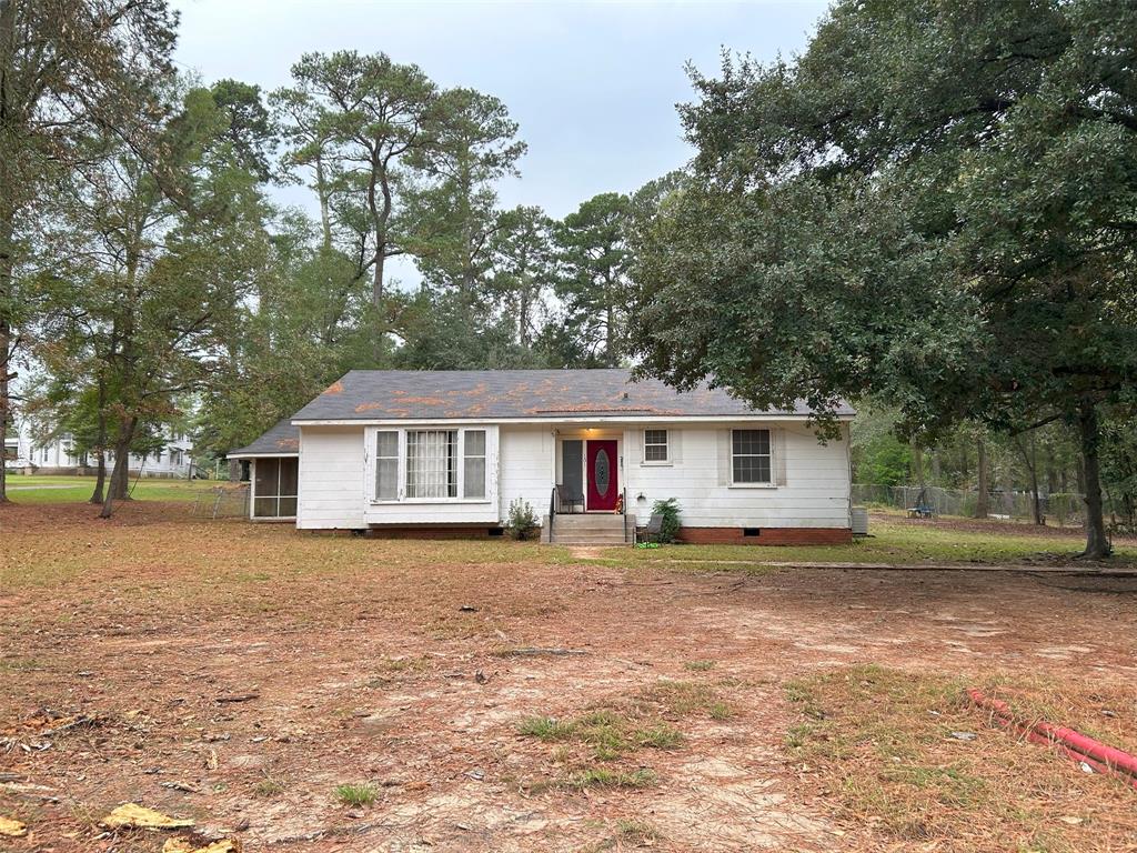 a house that has a tree in front of it