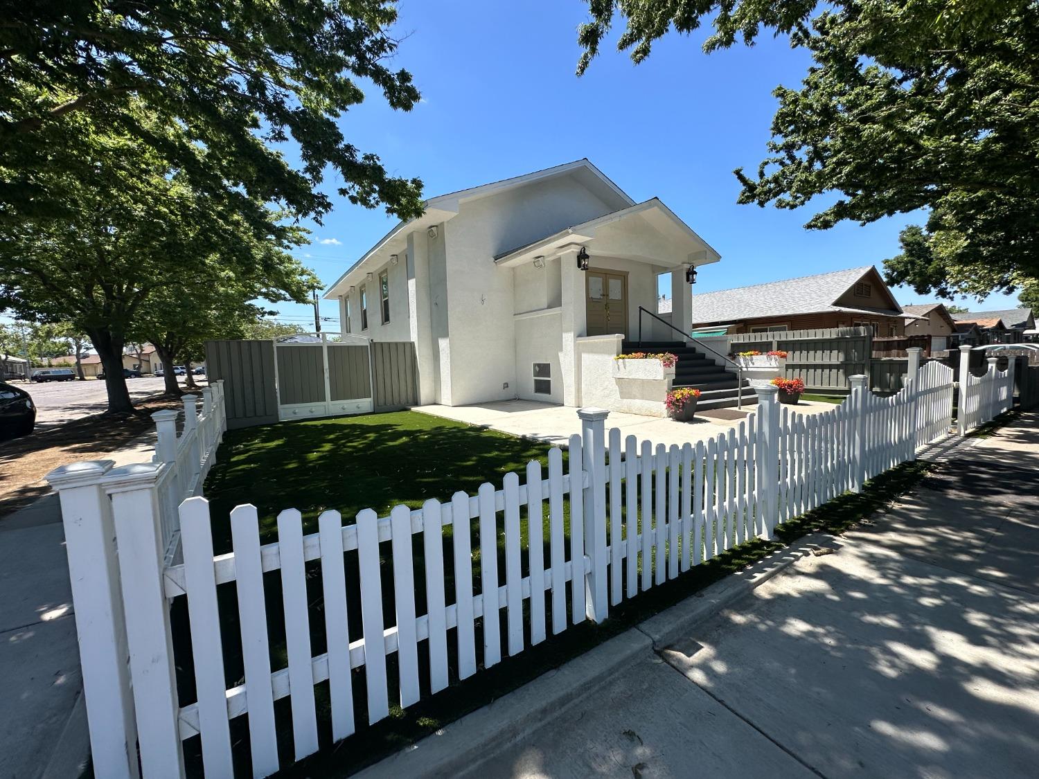 a front view of a house with a garden