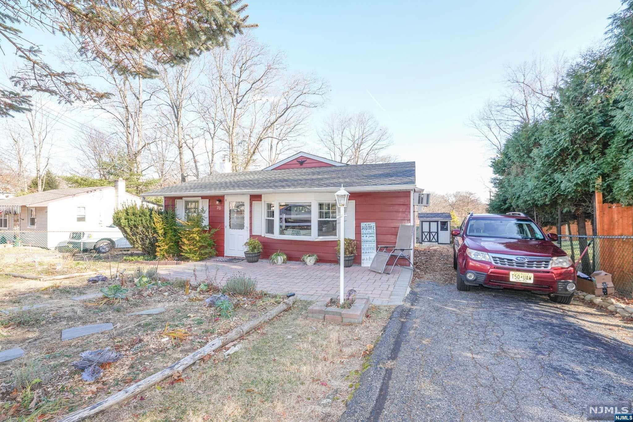 a front view of a house with a yard and seating space