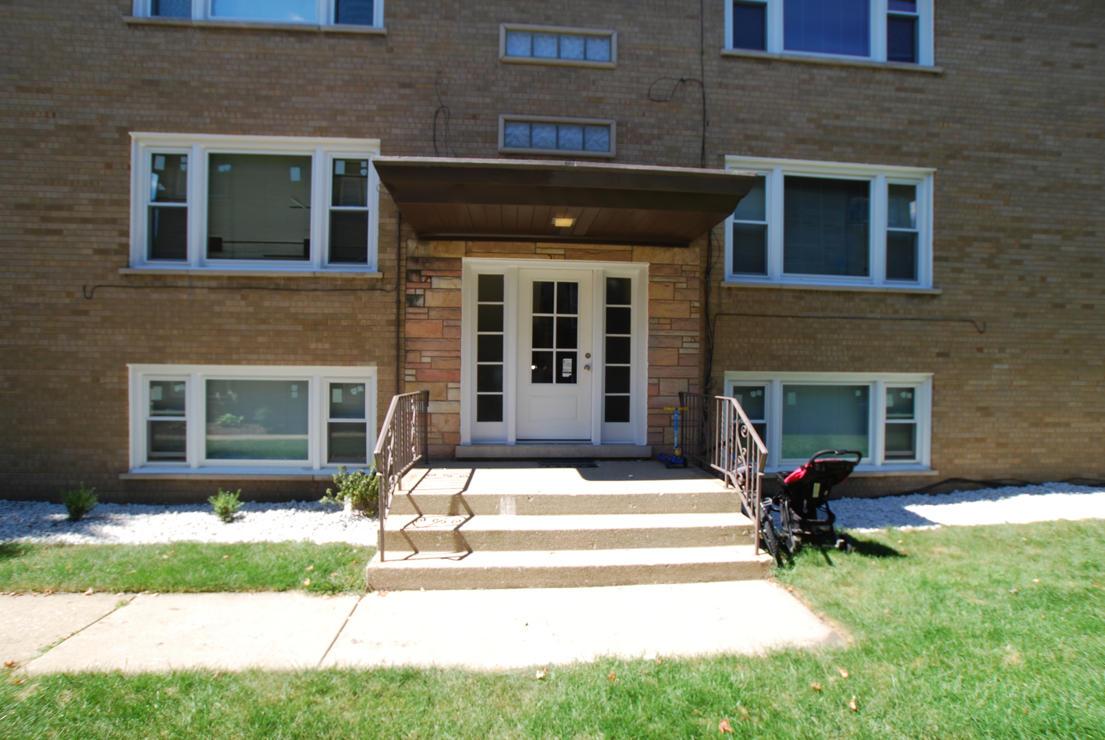 a front view of a house with garden and seating area