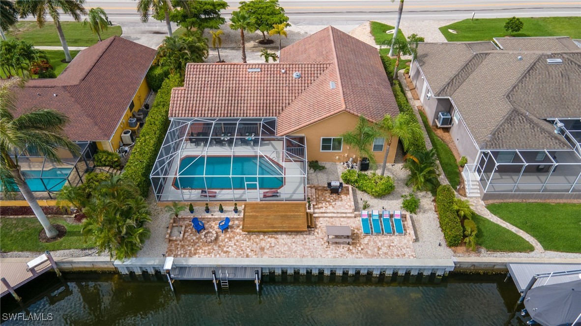 an aerial view of residential houses with outdoor space and lake view