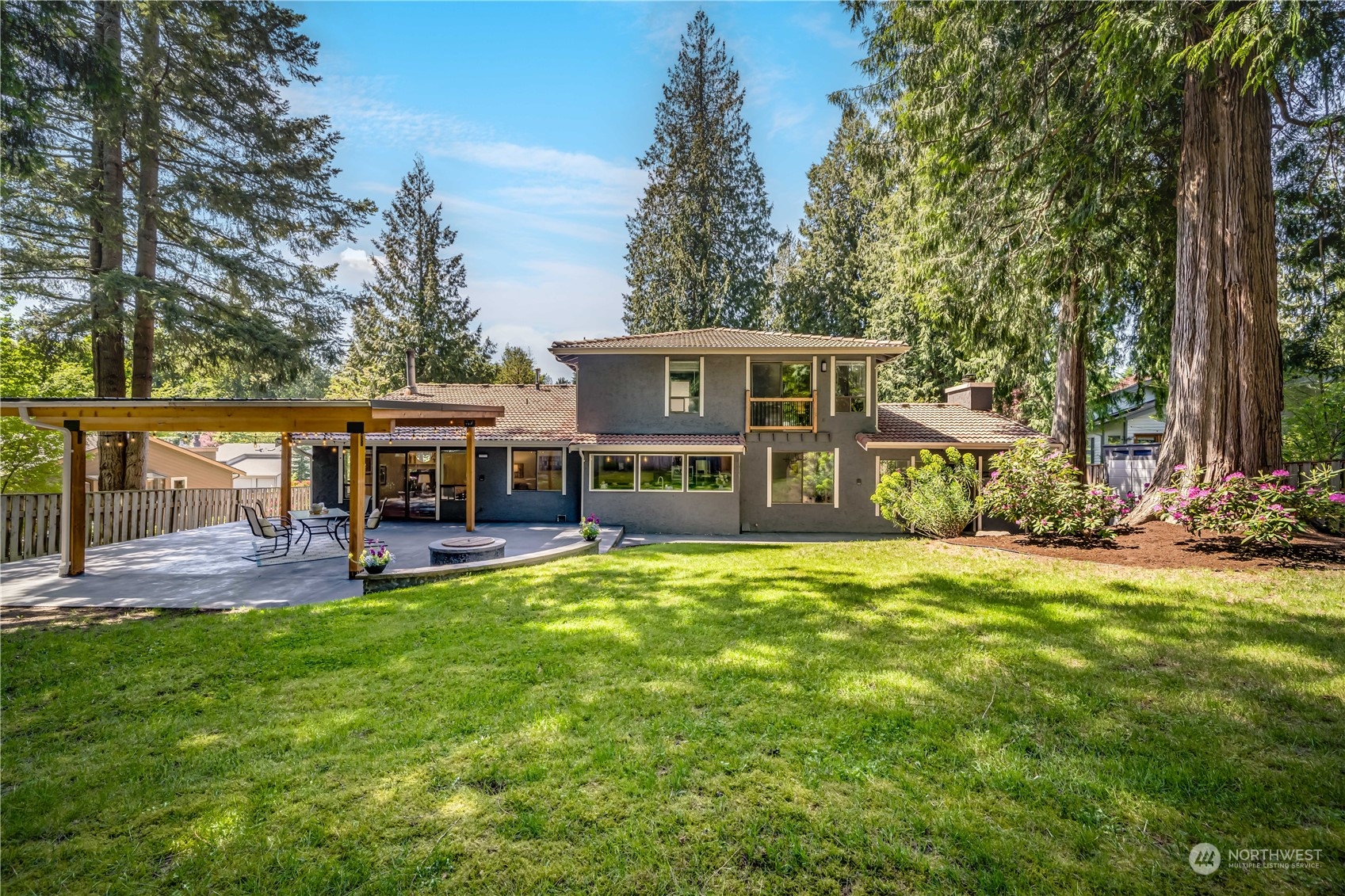 a view of a house with a yard and sitting area