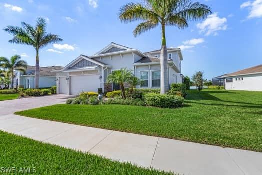 View of front of house with a front yard and a garage