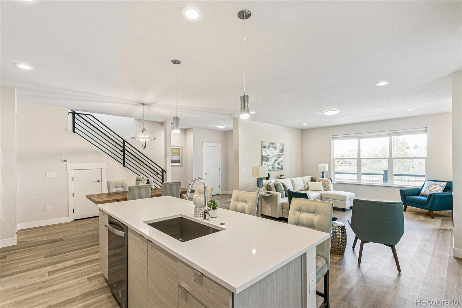 a kitchen with a stove a kitchen island with a sink table and chairs