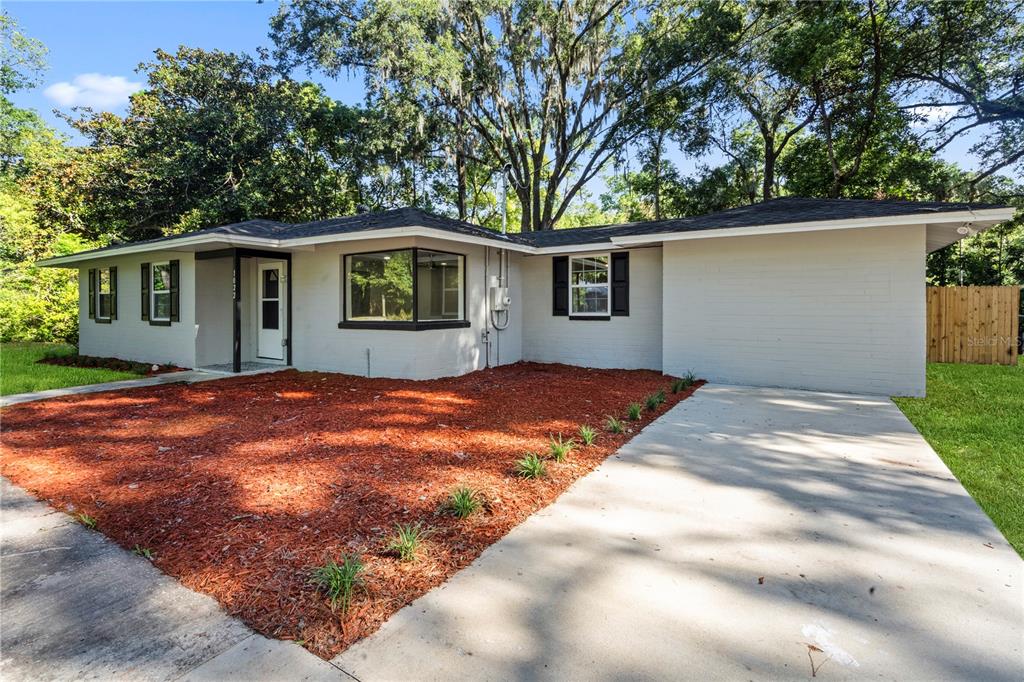 a backyard of a house with large trees