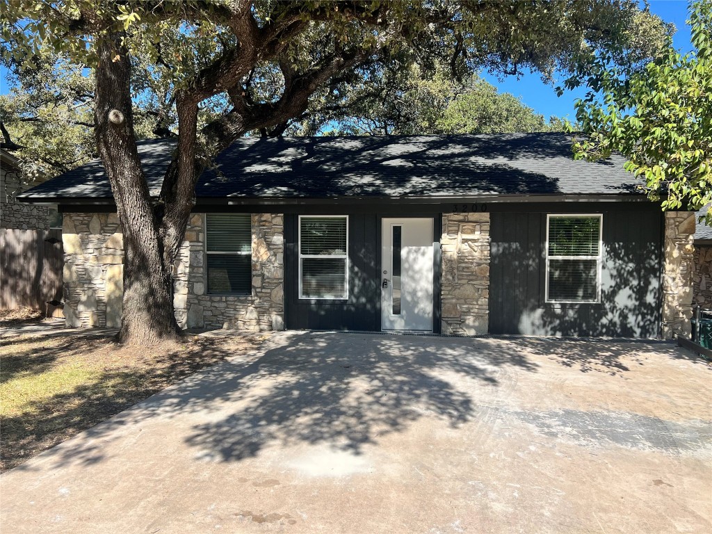 a view of a house with a tree in the yard