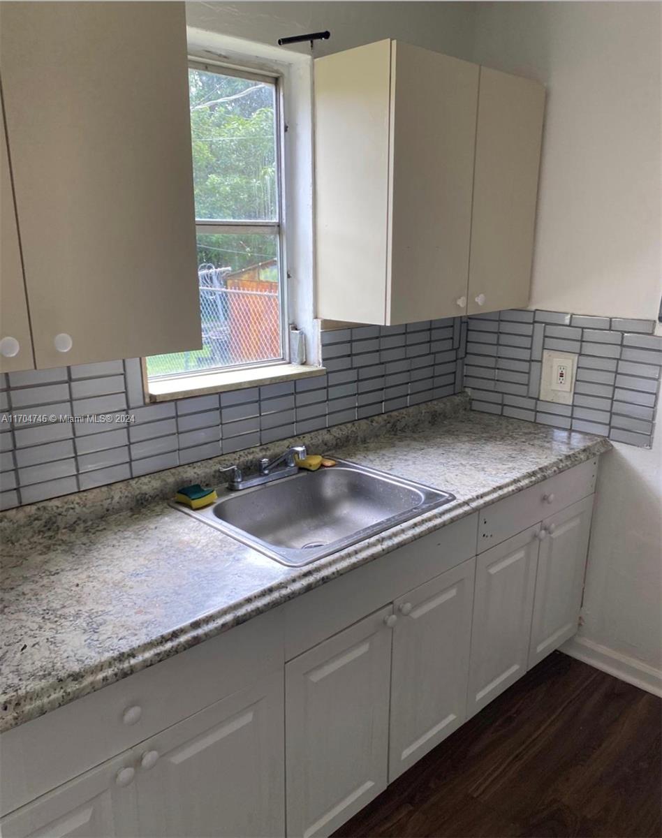 a kitchen with a sink and cabinets