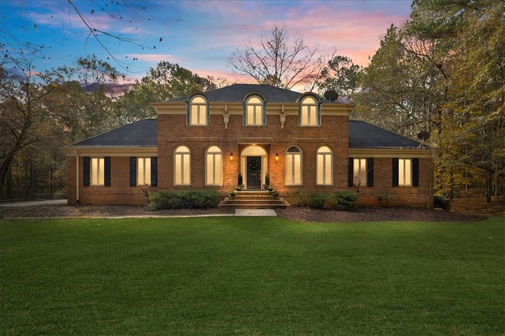 a front view of a house with a garden