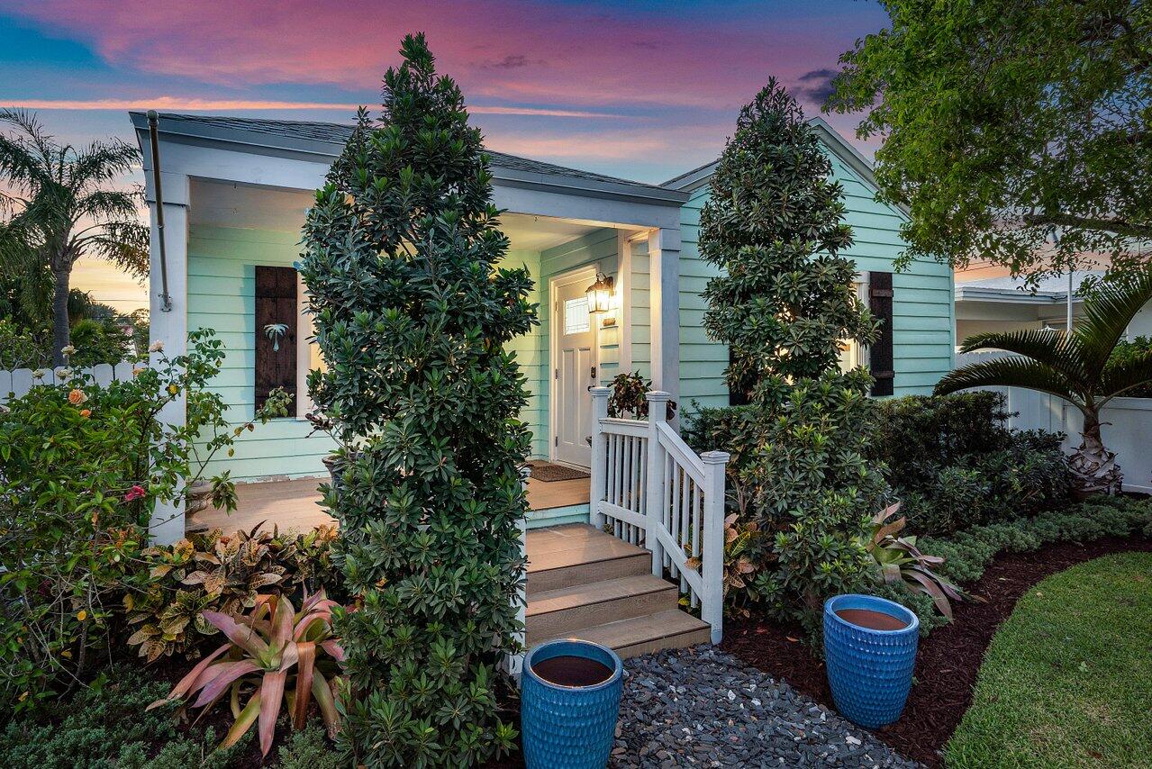 a view of a house with potted plants