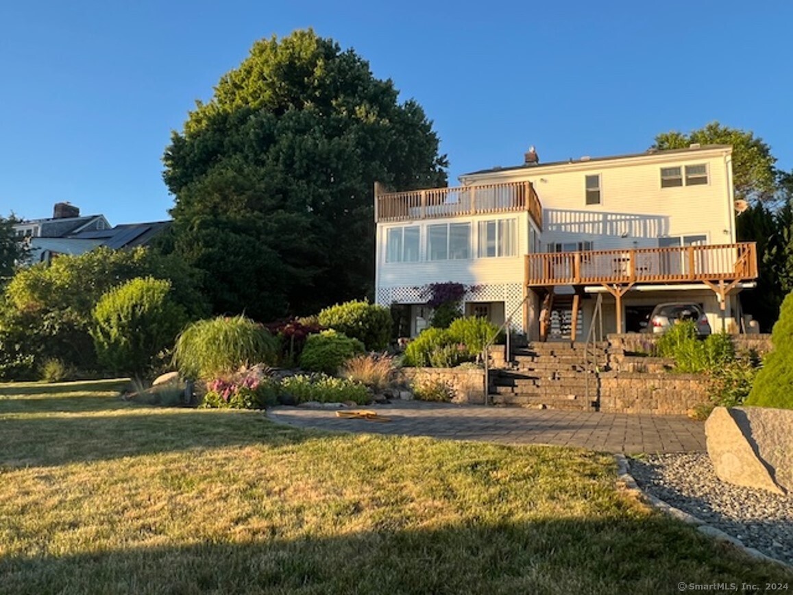 a view of a house with yard and sitting area