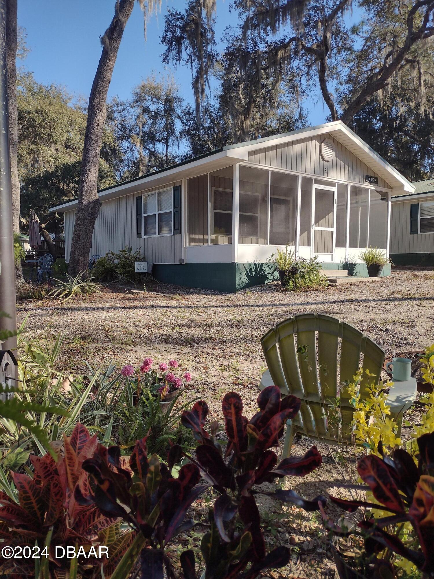 a view of a house with swimming pool and sitting area