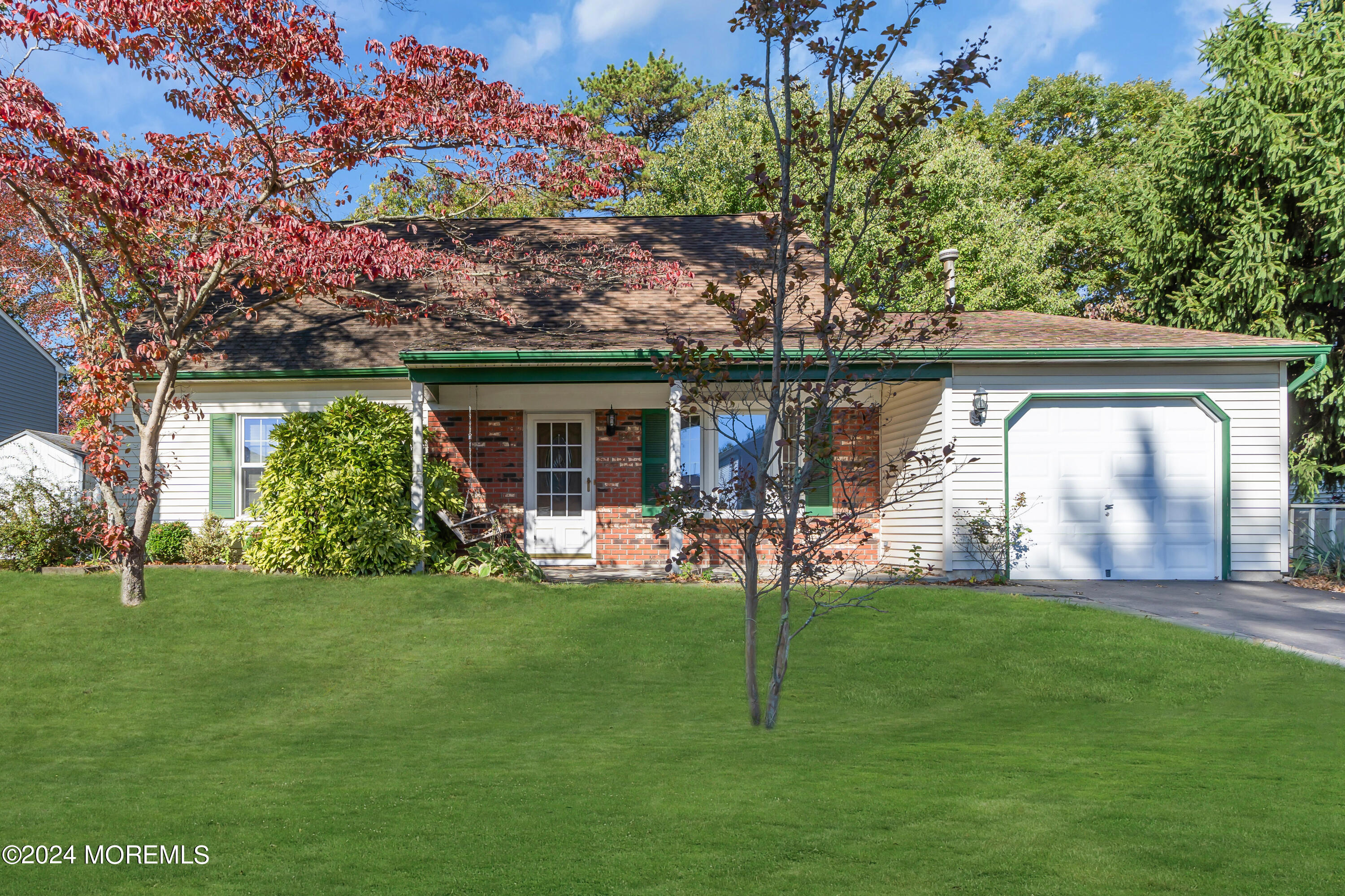 a view of a house with a yard and porch