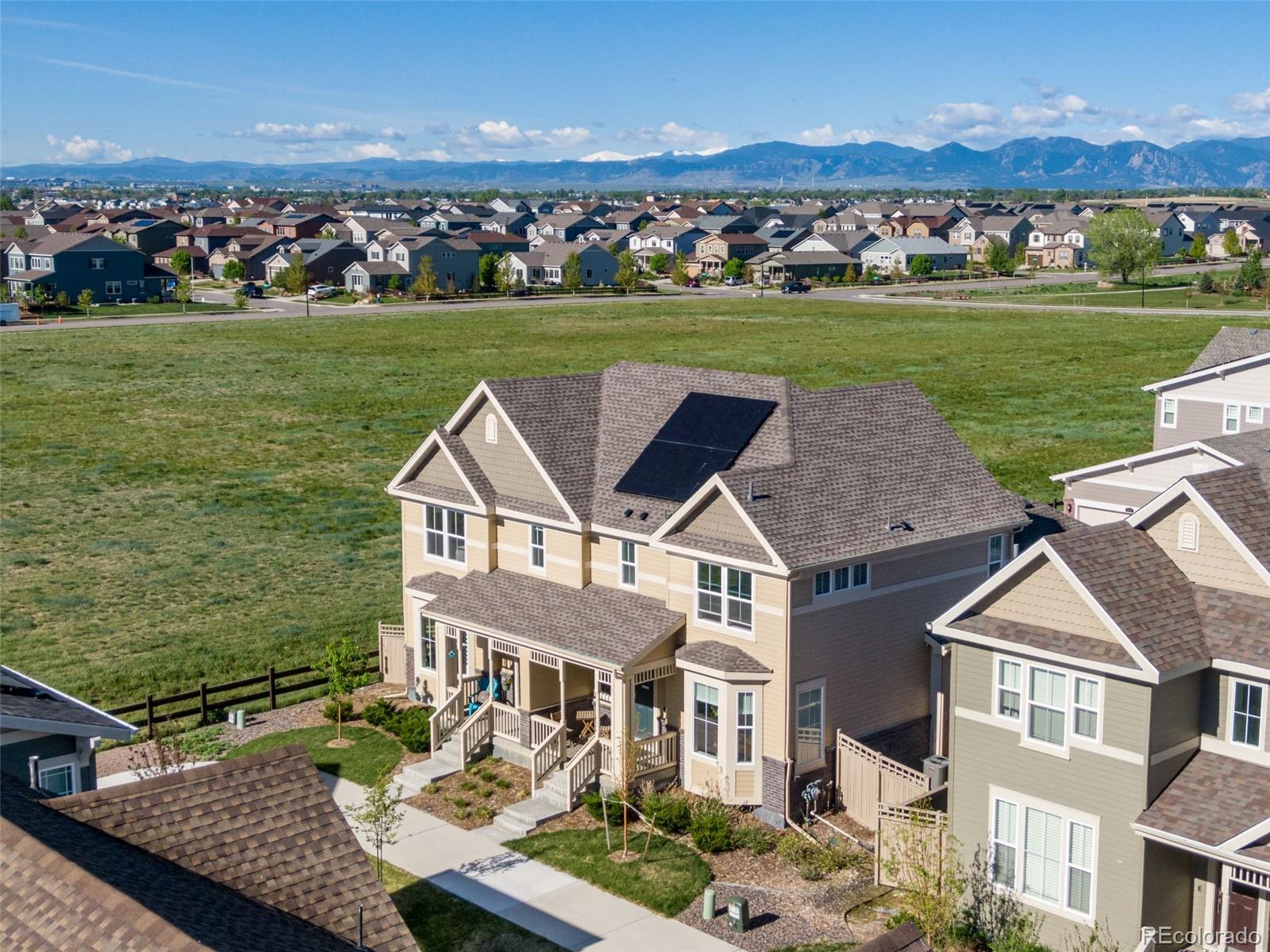 an aerial view of a house with a garden and lake view