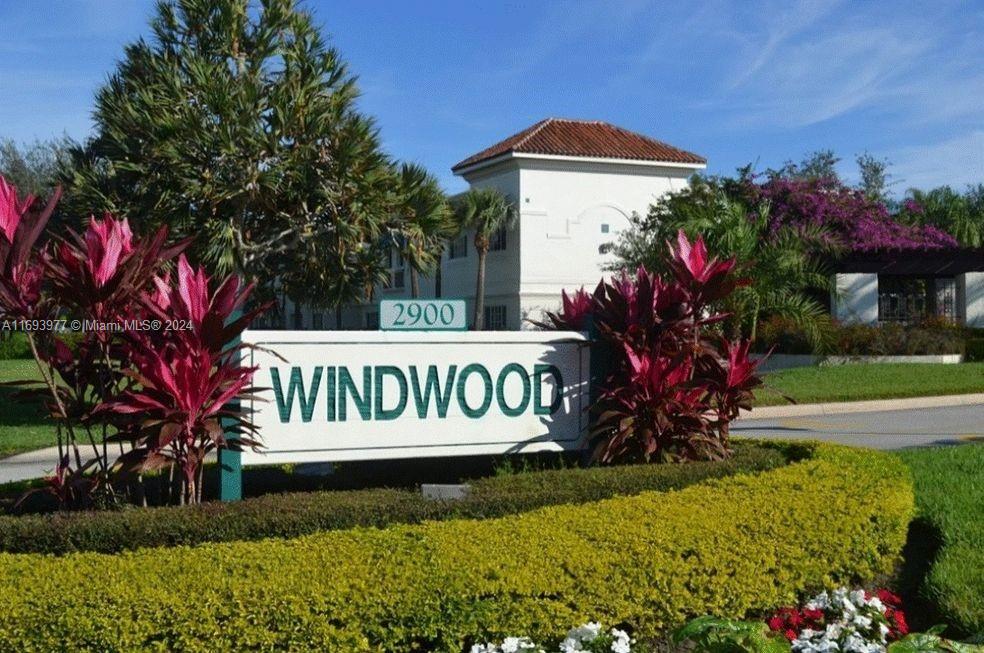 a view of sign board with flower around