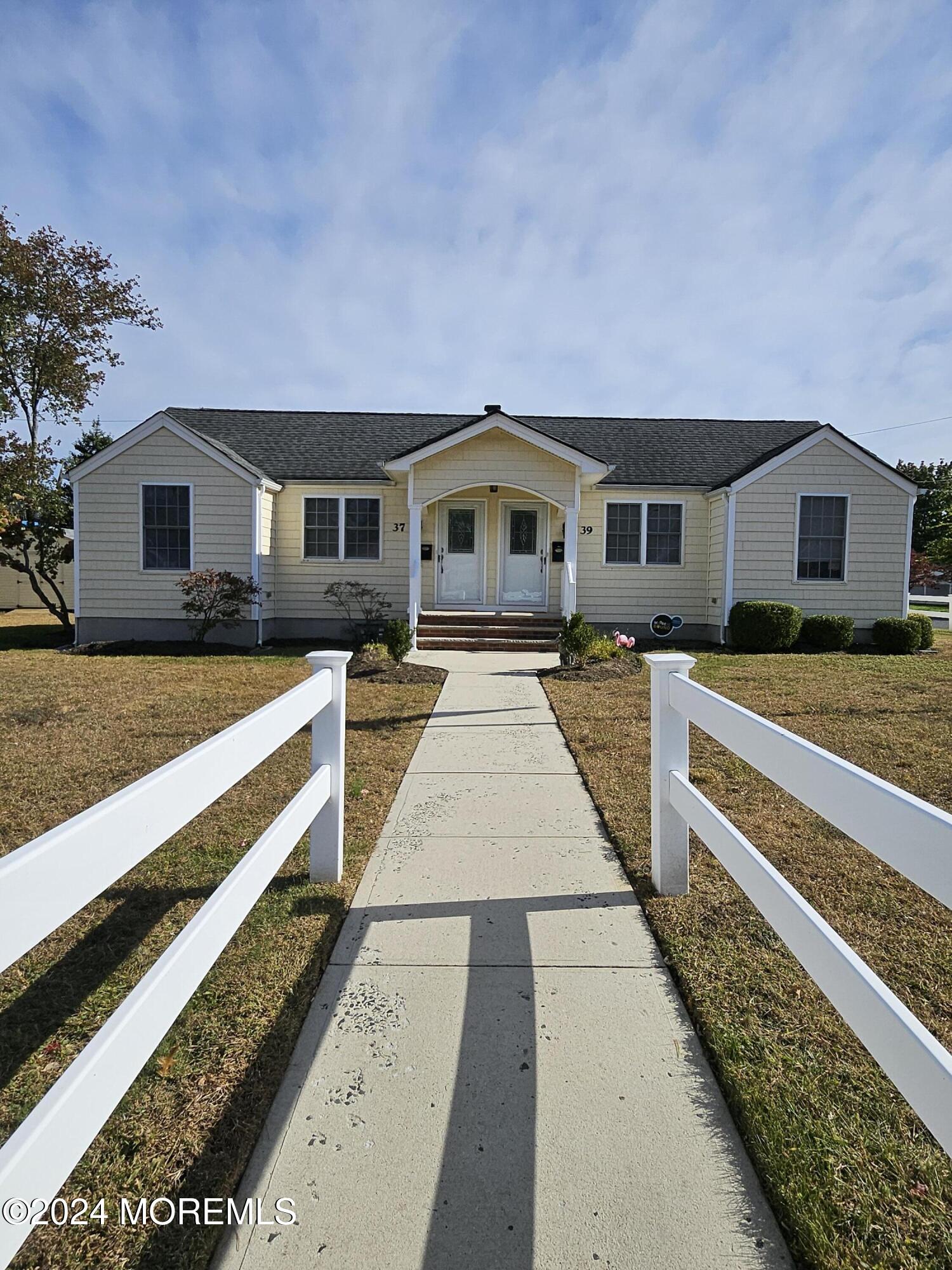 a front view of a house with a yard