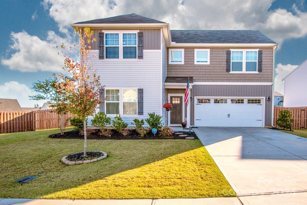 a front view of a house with a yard