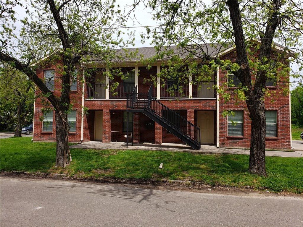 front view of house with a tree in front of it